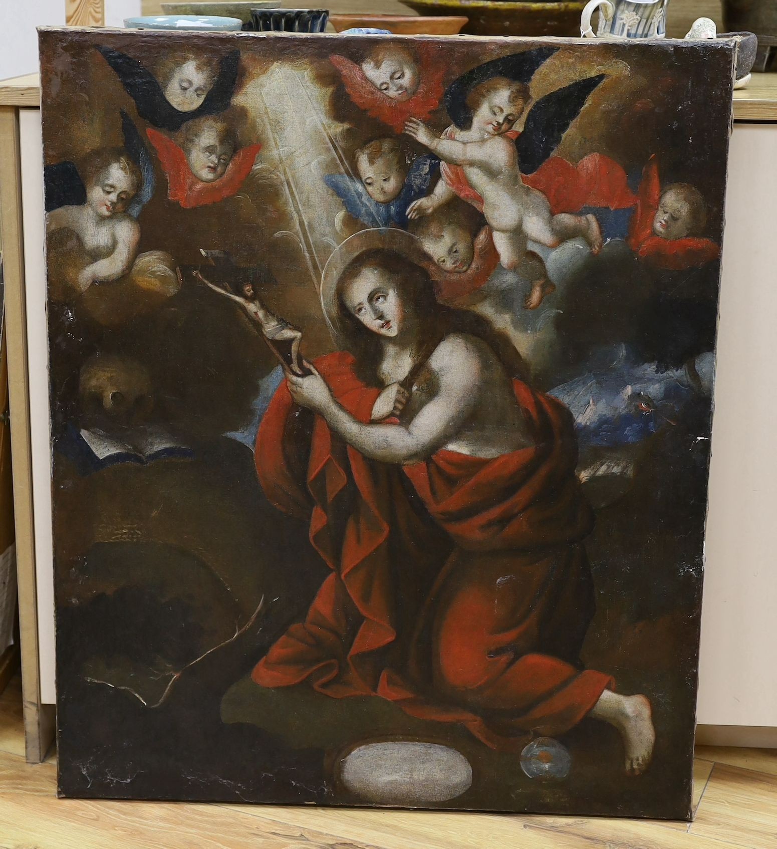 Early 19th century Spanish School, oil on canvas, Saint at prayer holding a crucifix, 80 x 67cm, unframed